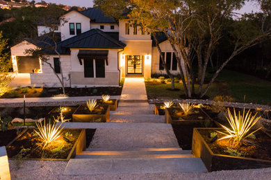 Design ideas for a large modern drought-tolerant and full sun front yard river rock walkway in Austin for summer.