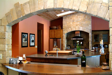 Inspiration for a large contemporary l-shaped ceramic tile and beige floor enclosed kitchen remodel in Phoenix with an undermount sink, shaker cabinets, light wood cabinets, granite countertops, brown backsplash, ceramic backsplash, stainless steel appliances and two islands