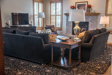 Mid-sized elegant open concept carpeted family room photo in Chicago with beige walls, a standard fireplace, a brick fireplace and a tv stand