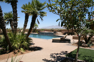 This is an example of a large southwestern drought-tolerant and full sun backyard water fountain landscape in Phoenix.
