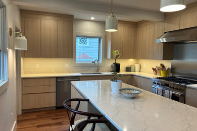 Inspiration for a mid-sized modern l-shaped medium tone wood floor and exposed beam eat-in kitchen remodel in Providence with a single-bowl sink, flat-panel cabinets, light wood cabinets, quartz countertops, quartz backsplash, stainless steel appliances, an island and white countertops