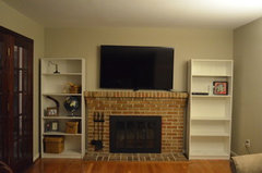 Shelving units next to shop fireplace