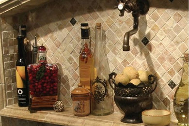 Eat-in kitchen - mediterranean eat-in kitchen idea in Boston with brown backsplash, stone tile backsplash and colored appliances