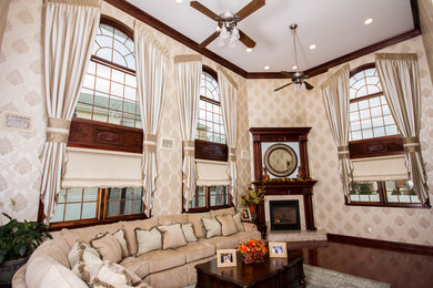 Mid-sized elegant open concept dark wood floor and brown floor family room photo in New York with beige walls, a corner fireplace, a wood fireplace surround and no tv