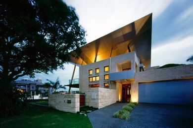 Design ideas for a contemporary two-storey beige exterior in Brisbane with stone veneer.