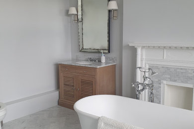 Large ensuite bathroom in London with grey walls.