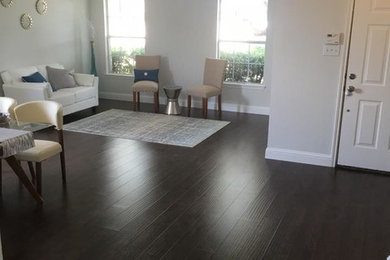Example of a large trendy enclosed dark wood floor family room design in Dallas