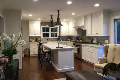 Mid-sized transitional kitchen photo in New York with gray backsplash, stainless steel appliances and an island