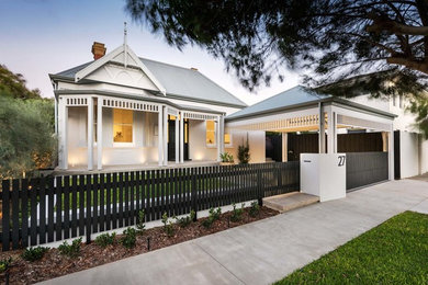 Inspiration for a mid-sized transitional one-storey brick white house exterior in Perth with a gable roof and a metal roof.
