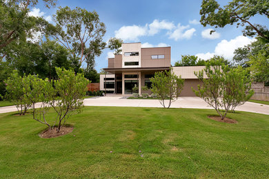 Photo of a mid-sized contemporary two-storey brick beige exterior in Dallas with a flat roof.