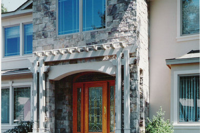 Inspiration for a large craftsman beige two-story mixed siding gable roof remodel in New York