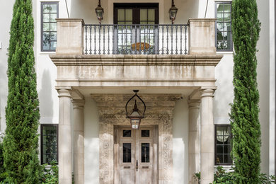 French country entryway photo in Houston with a light wood front door