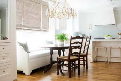 Inspiration for a contemporary medium tone wood floor and brown floor kitchen remodel in Birmingham with a farmhouse sink, white backsplash, stainless steel appliances, an island and white countertops
