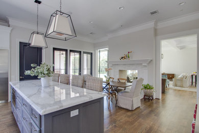 Transitional open concept kitchen photo in Houston with recessed-panel cabinets and an island