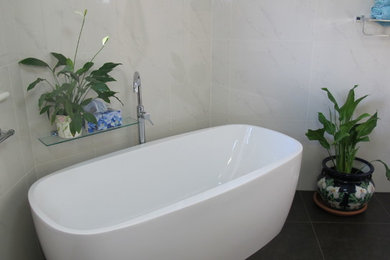 Photo of a large contemporary master bathroom in Melbourne with an open shower, white tile, porcelain tile, white walls and porcelain floors.
