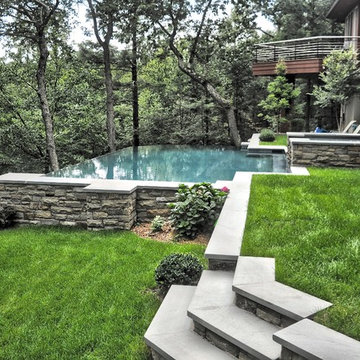 cliffside vanishing edge pool with raised spa + surge current