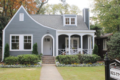 This is an example of a mid-sized traditional two-storey grey exterior in Birmingham with vinyl siding and a gable roof.