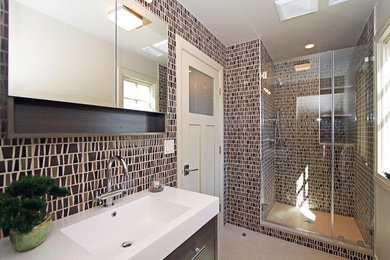Inspiration for a large modern master brown tile, multicolored tile and ceramic tile porcelain tile and beige floor alcove shower remodel in New York with flat-panel cabinets, dark wood cabinets, multicolored walls, an integrated sink and a hinged shower door