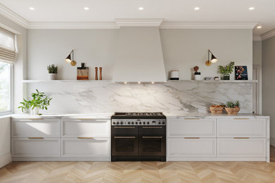 Design ideas for a large contemporary galley enclosed kitchen in London with shaker cabinets, white cabinets, marble worktops, white splashback, marble splashback, black appliances, white worktops, a belfast sink and light hardwood flooring.