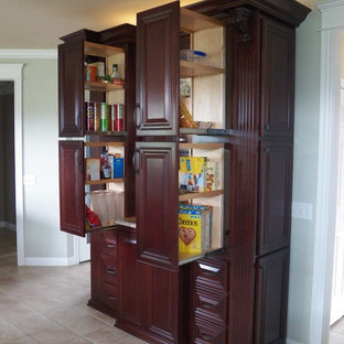 Traditional kitchen pantry photos - Elegant ceramic floor and beige floor kitchen pantry photo in Cincinnati with raised-panel cabinets, dark wood cabinets, granite countertops and beige countertops