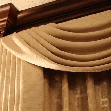 Swags overlaying pinch pleated curtains
