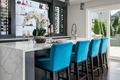 Inspiration for a huge contemporary galley dark wood floor and brown floor seated home bar remodel in Atlanta with an undermount sink, flat-panel cabinets, black cabinets, quartz countertops, white countertops and glass sheet backsplash