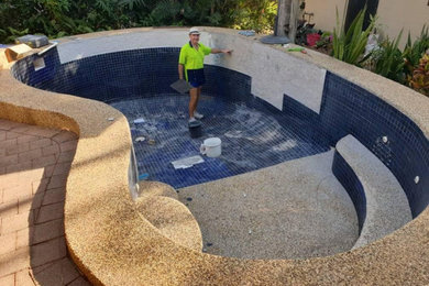 This is an example of a large modern backyard custom-shaped aboveground pool in Darwin with with a pool and tile.