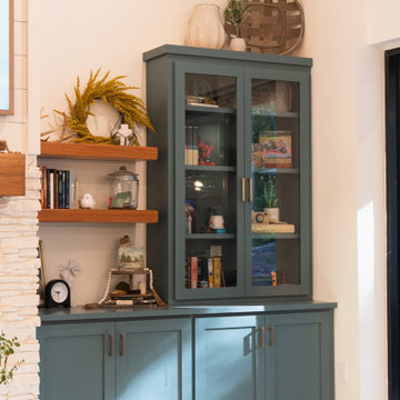 Custom Teal Built-In Cabinetry with Glass Display and Floating Shelves in Jasper