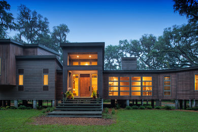 Example of a mid-sized mountain style entryway design in Jacksonville with brown walls and a medium wood front door