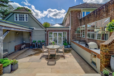 Photo of a large contemporary patio in London with a bbq area.