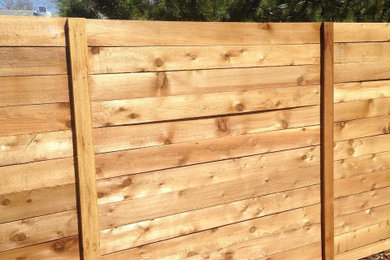 Design ideas for a rustic wood fence landscaping in Denver.