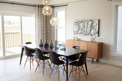 Example of a transitional light wood floor and beige floor enclosed dining room design in Edmonton with beige walls