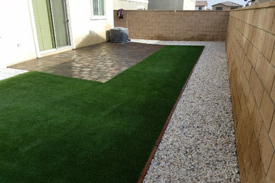 This is an example of a mid-sized traditional partial sun backyard stone landscaping in Los Angeles.