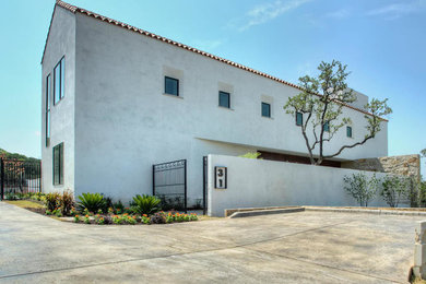 Inspiration for a mid-sized modern white two-story stucco exterior home remodel in Austin