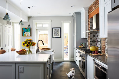 Eat-in kitchen - mid-sized eclectic single-wall gray floor eat-in kitchen idea in DC Metro with gray cabinets, stainless steel appliances, an island and white countertops