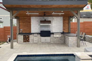 Transitional backyard patio in Nashville with an outdoor kitchen, natural stone pavers and a gazebo/cabana.