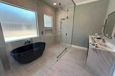 Bathroom - large master beige tile and porcelain tile limestone floor and beige floor bathroom idea in Dallas with a wall-mount toilet, quartzite countertops, a hinged shower door and a niche