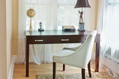 Home office - small transitional freestanding desk light wood floor home office idea in New York with beige walls