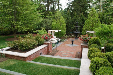 Inspiration for a mid-sized traditional partial sun backyard brick landscaping in New York for spring.