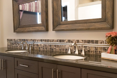 Example of a trendy master multicolored tile and stone tile light wood floor bathroom design in San Luis Obispo with furniture-like cabinets, blue cabinets, marble countertops, a one-piece toilet, beige walls and a drop-in sink