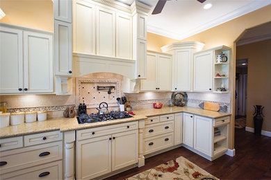 Large elegant dark wood floor open concept kitchen photo in Other with recessed-panel cabinets, white cabinets, quartz countertops, beige backsplash, stone tile backsplash, stainless steel appliances and no island