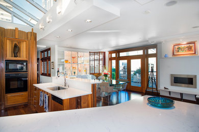Inspiration for a large eclectic dark wood floor kitchen/dining room combo remodel in Seattle with white walls and a ribbon fireplace