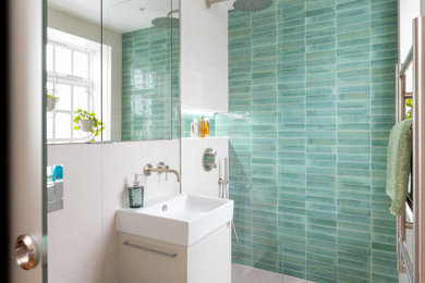 Inspiration for a contemporary shower room bathroom in London with a wall mounted toilet, beige walls, ceramic flooring, a wall-mounted sink, beige floors, an open shower, a feature wall, a single sink, a floating vanity unit and an alcove shower.