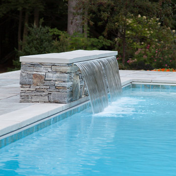 Double Cascading waterfall into pool with bench underwater
