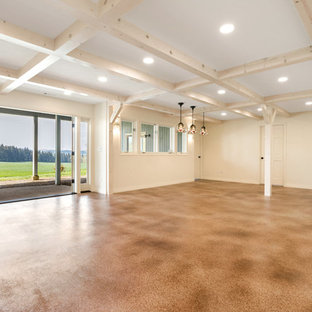 Inspiration for a large rustic walk-out basement in Portland with white walls, concrete flooring, a wood burning stove, a brick fireplace surround and brown floors.