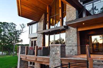 Design ideas for an expansive contemporary three-storey exterior in Minneapolis with stone veneer.