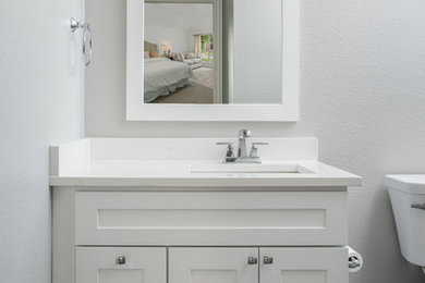 Bathroom - mid-sized contemporary gray tile and porcelain tile porcelain tile bathroom idea in Dallas with shaker cabinets, white cabinets, a drop-in sink, quartz countertops and white countertops