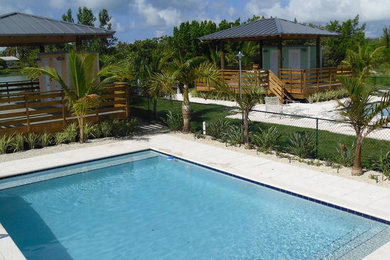 Hot tub - backyard tile and rectangular hot tub idea in Miami