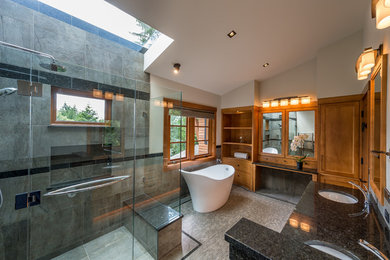 Bathroom - large modern master gray tile pebble tile floor bathroom idea in Vancouver with an undermount sink, recessed-panel cabinets, light wood cabinets, granite countertops, a one-piece toilet and beige walls
