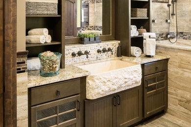 Inspiration for a large rustic master brown tile and porcelain tile porcelain tile doorless shower remodel in Providence with beaded inset cabinets, dark wood cabinets, a two-piece toilet, green walls, a trough sink and granite countertops
